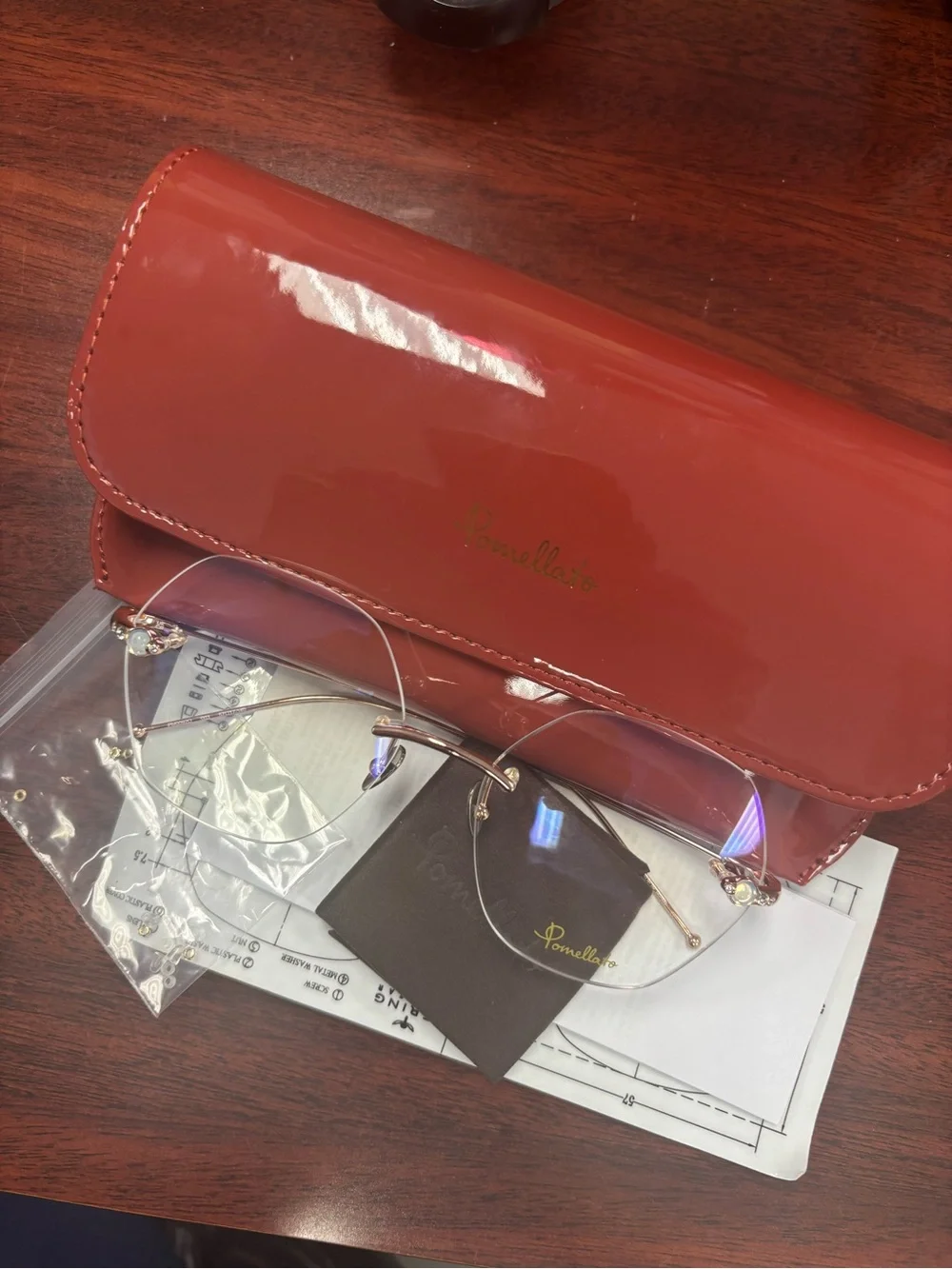 Pomellato Gold Rimless Glasses with Red Case